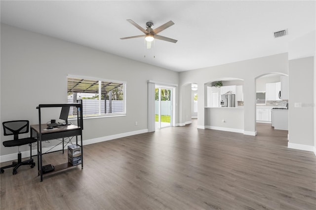 4852 Trinidad Dr, Land O Lakes, FL 34639 - living area with a ceiling fan, dark wood-type flooring, baseboards, and arched walkways