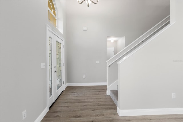 4852 Trinidad Dr, Land O Lakes, FL 34639 - foyer entrance with stairs, a chandelier, wood finished floors, and baseboards