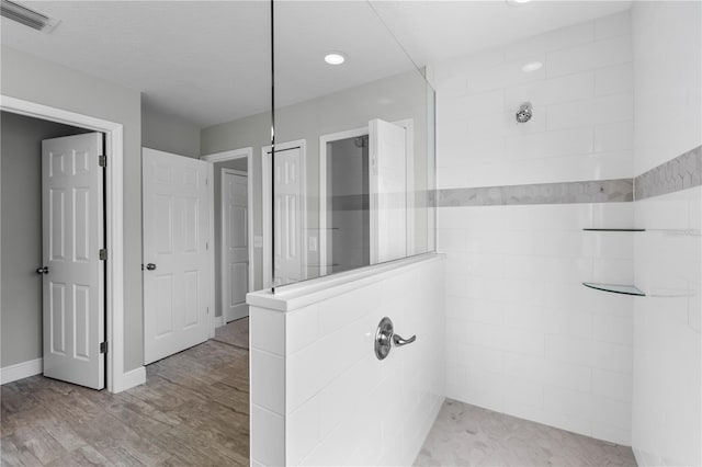 4852 Trinidad Dr, Land O Lakes, FL 34639 - bathroom with tiled shower, wood finished floors, and recessed lighting