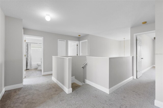 4852 Trinidad Dr, Land O Lakes, FL 34639 - hallway with an upstairs landing, carpet floors, and baseboards