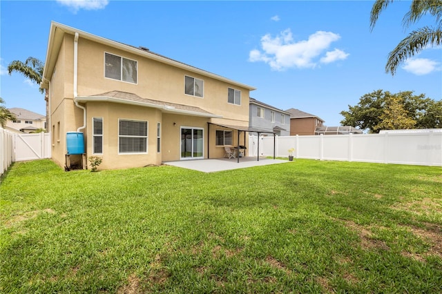 4852 Trinidad Dr, Land O Lakes, FL 34639 - back of property with stucco siding, a patio area, and a gate