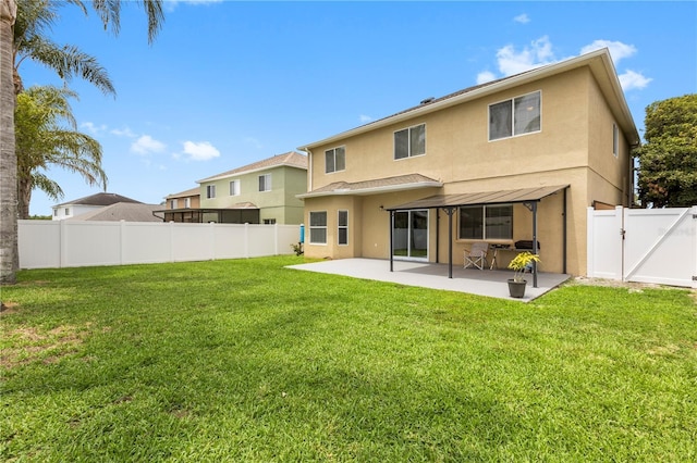 4852 Trinidad Dr, Land O Lakes, FL 34639 - back of property with stucco siding, a patio, and a gate