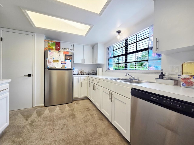 12701 N 57th St -, Unit Tampa, FL 33617 - kitchen featuring stainless steel appliances, a sink, light colored carpet, light countertops, and white cabinets