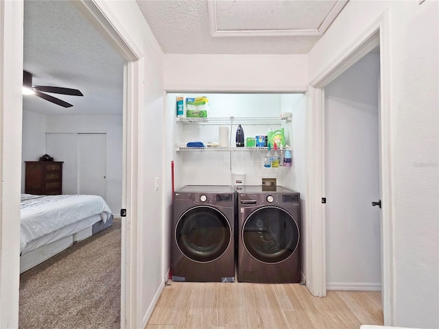 12701 N 57th St -, Unit Tampa, FL 33617 - washroom with washing machine and dryer, baseboards, wood finished floors, a ceiling fan, and a textured ceiling