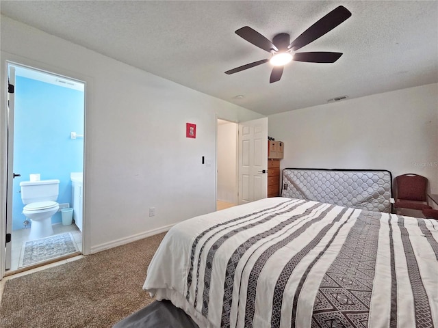 12701 N 57th St -, Unit Tampa, FL 33617 - carpeted bedroom featuring a textured ceiling, baseboards, a ceiling fan, and ensuite bath