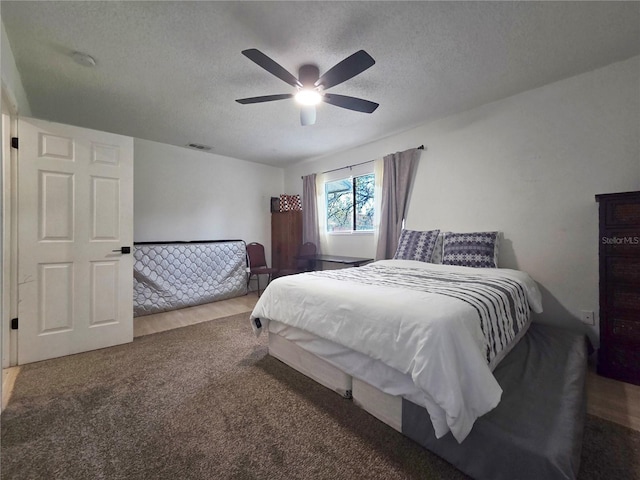 12701 N 57th St -, Unit Tampa, FL 33617 - carpeted bedroom featuring a textured ceiling and a ceiling fan