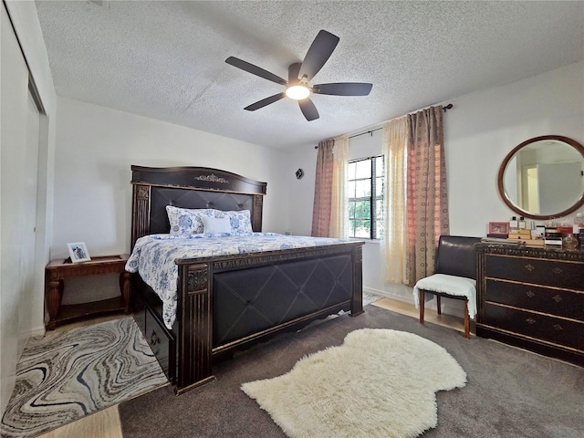 12701 N 57th St -, Unit Tampa, FL 33617 - carpeted bedroom with a textured ceiling, a ceiling fan, and baseboards