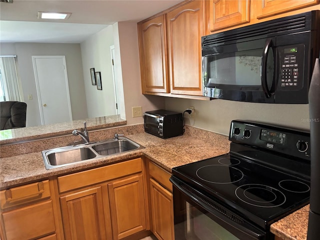 3814 N Lake Dr Unit 65, Tampa, FL 33614 - kitchen with black appliances, a sink, and brown cabinetry
