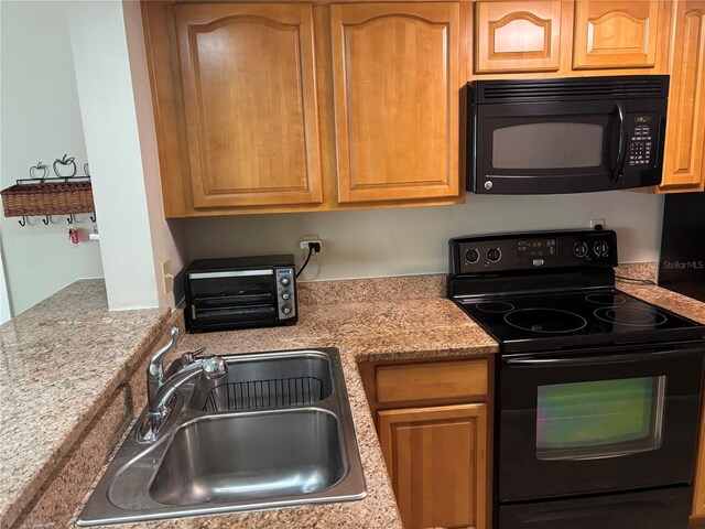 3814 N Lake Dr Unit 65, Tampa, FL 33614 - kitchen featuring black appliances and a sink