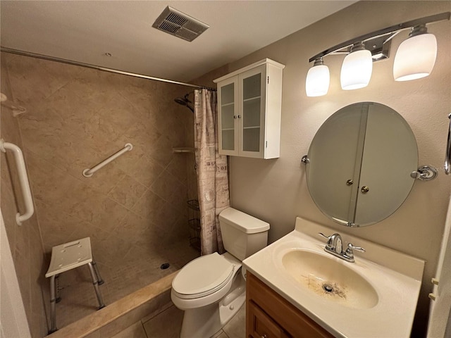 3814 N Lake Dr Unit 65, Tampa, FL 33614 - full bathroom featuring toilet, tiled shower, vanity, and tile patterned floors