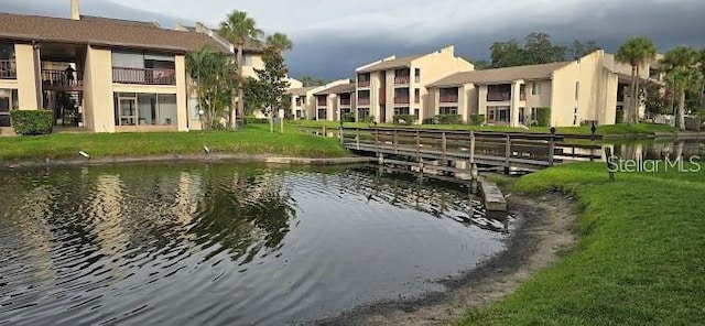 3814 N Lake Dr Unit 65, Tampa, FL 33614 - dock featuring a water view and a yard