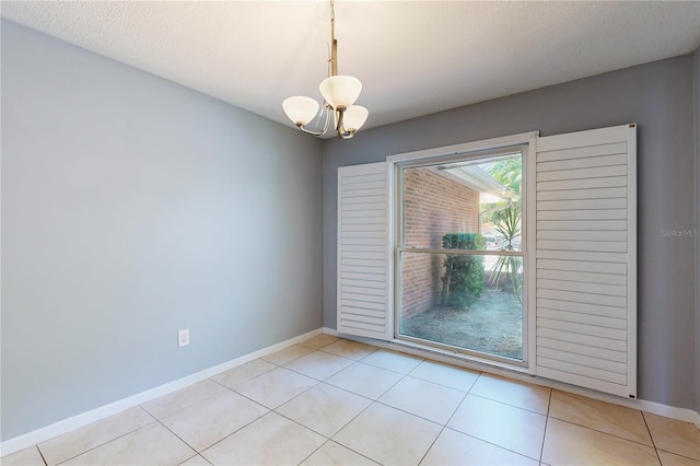 2138 Viola Dr, Clearwater, FL 33764 - spare room with a chandelier, baseboards, and light tile patterned floors