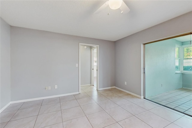 2138 Viola Dr, Clearwater, FL 33764 - unfurnished room with a ceiling fan, light tile patterned floors, and baseboards