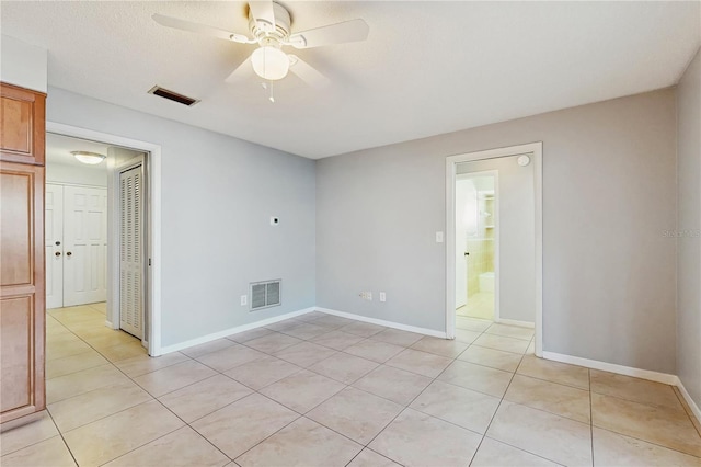 2138 Viola Dr, Clearwater, FL 33764 - unfurnished room featuring ceiling fan, light tile patterned floors, and baseboards
