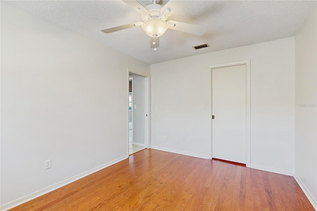 2138 Viola Dr, Clearwater, FL 33764 - unfurnished bedroom with light wood-style flooring, baseboards, a textured ceiling, and ceiling fan