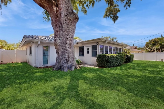 2138 Viola Dr, Clearwater, FL 33764 - rear view of property with a tile roof, stucco siding, and a gate