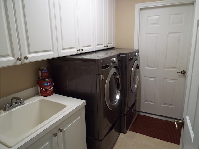 13860 Avon Park Cir Unit 104, Fort Myers, FL 33912 - laundry area with cabinet space, washer and clothes dryer, and light tile patterned floors