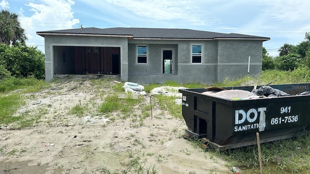 18581 Lake Worth Blvd, Port Charlotte, FL 33948 - rear view of property with an attached garage, stucco siding, and driveway