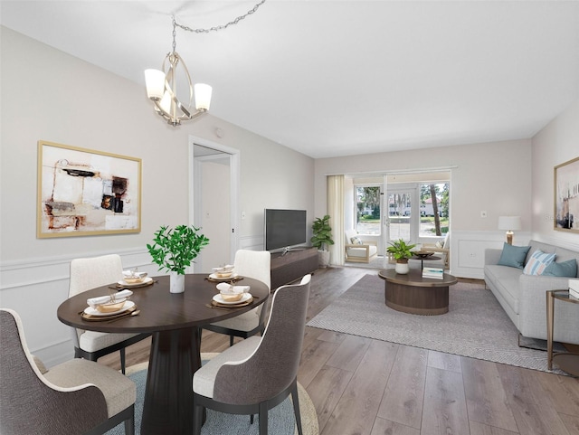 10356 Carrollwood Ln Unit 204, Tampa, FL 33618 - dining area with wood finished floors, wainscoting, and a chandelier