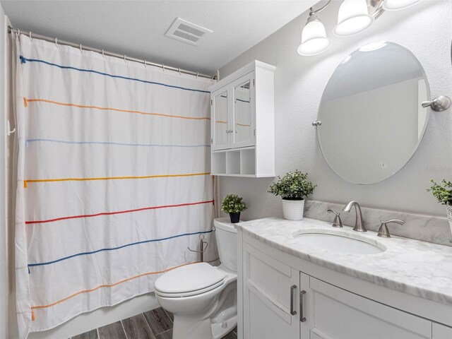 10356 Carrollwood Ln Unit 204, Tampa, FL 33618 - bathroom featuring vanity, toilet, and wood finished floors