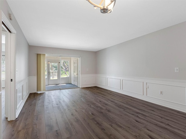 10356 Carrollwood Ln Unit 204, Tampa, FL 33618 - unfurnished room featuring dark wood-style flooring, wainscoting, and a decorative wall