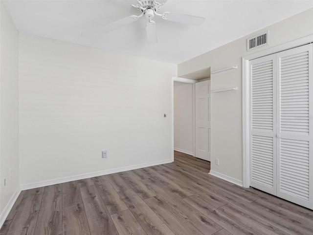 10356 Carrollwood Ln Unit 204, Tampa, FL 33618 - unfurnished bedroom with wood finished floors, a closet, ceiling fan, and baseboards
