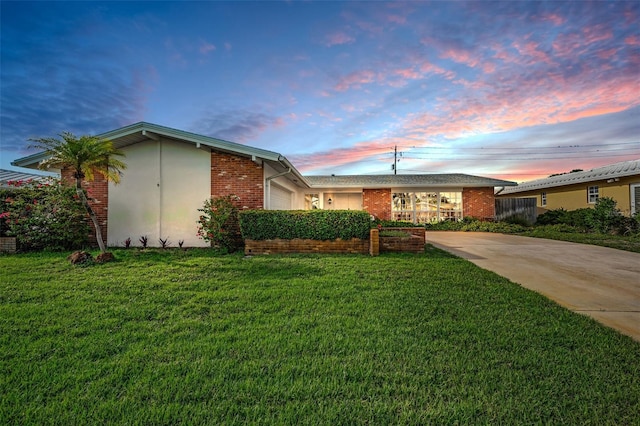 14341 Passage Way, Seminole, FL 33776 - single story home featuring a garage, a yard, and brick siding
