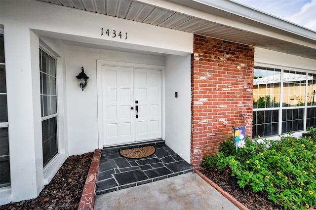 14341 Passage Way, Seminole, FL 33776 - property entrance featuring stucco siding