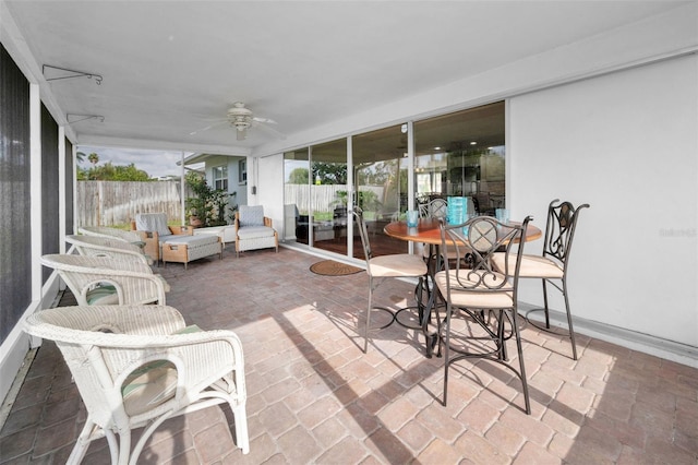 14341 Passage Way, Seminole, FL 33776 - sunroom / solarium with a ceiling fan and outdoor dining area