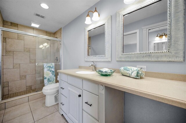 14341 Passage Way, Seminole, FL 33776 - bathroom featuring toilet, a shower stall, vanity, and tile patterned floors