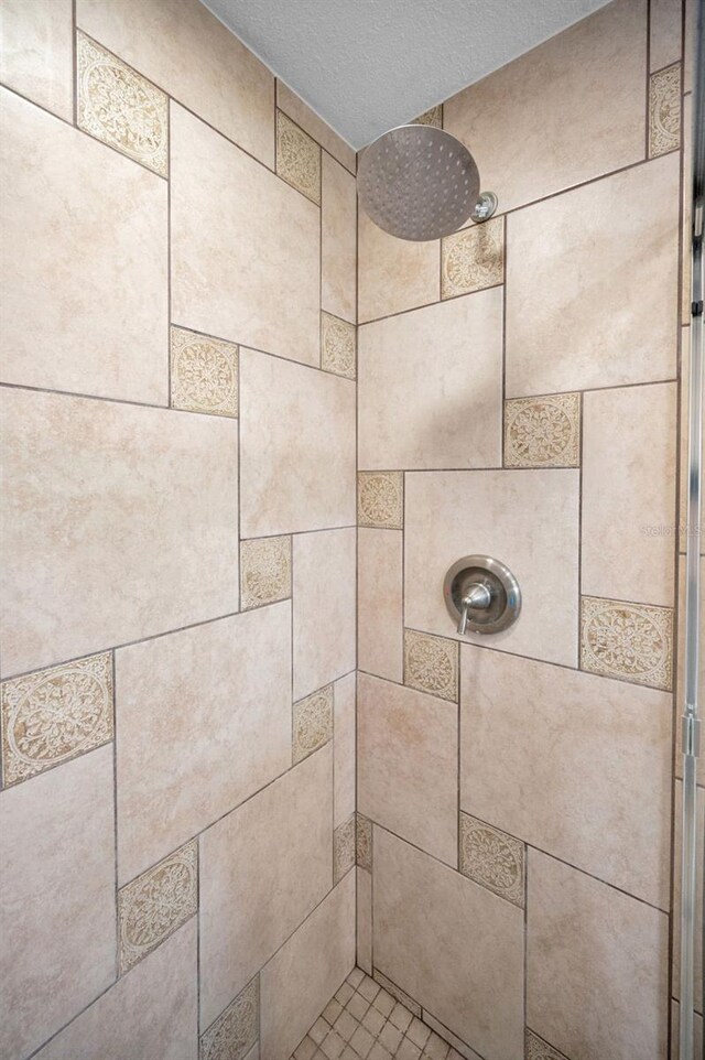 14341 Passage Way, Seminole, FL 33776 - bathroom view of a tile shower and a textured ceiling