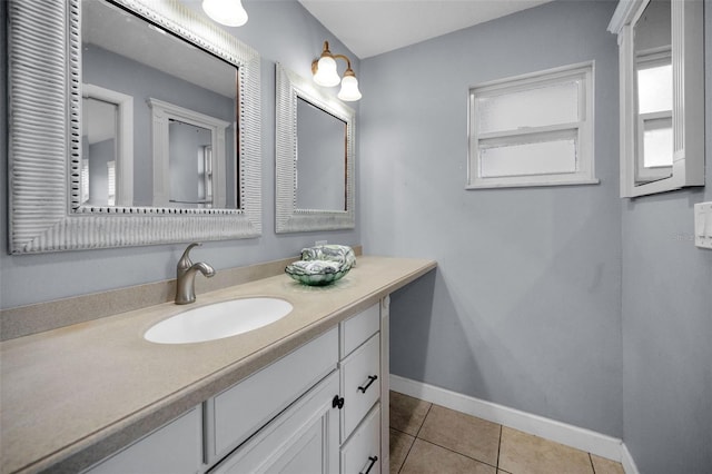 14341 Passage Way, Seminole, FL 33776 - bathroom with baseboards, vanity, and tile patterned floors