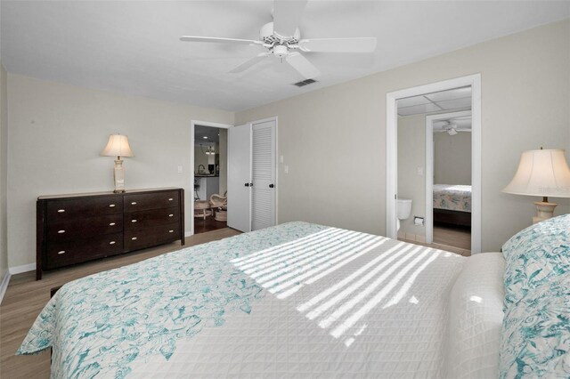 14341 Passage Way, Seminole, FL 33776 - bedroom with wood finished floors, ceiling fan, ensuite bathroom, baseboards, and a closet