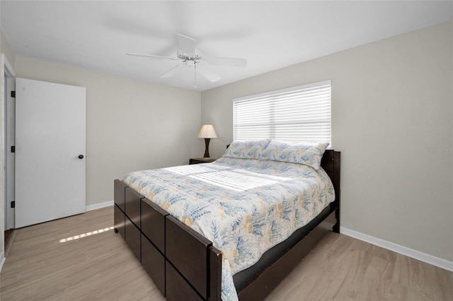 14341 Passage Way, Seminole, FL 33776 - bedroom with light wood finished floors, baseboards, and ceiling fan