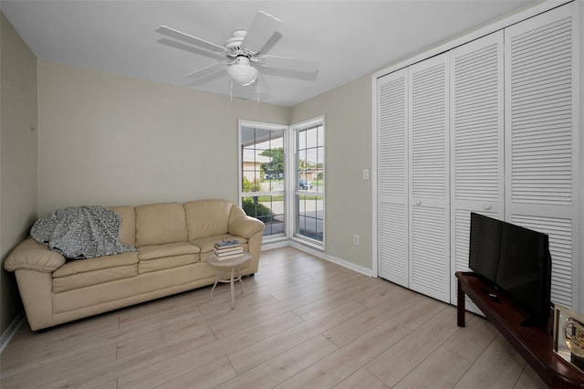 14341 Passage Way, Seminole, FL 33776 - living room featuring light wood-style flooring, baseboards, and ceiling fan