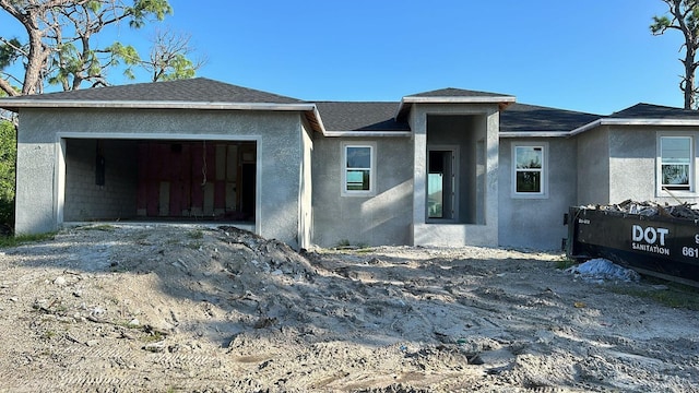 14024 Wenzel Ave, Port Charlotte, FL 33981 - view of front of home featuring a garage, stucco siding, driveway, and a shingled roof