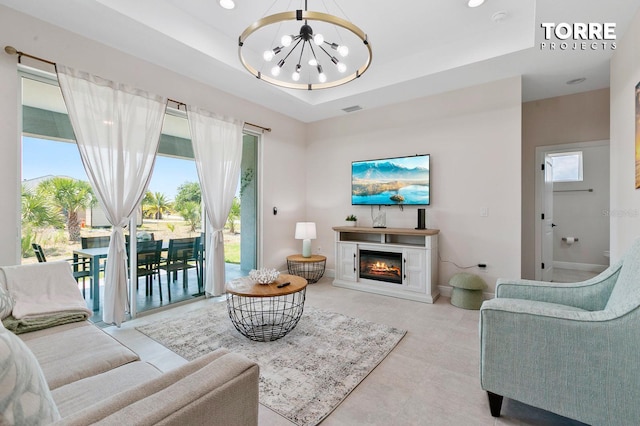 14024 Wenzel Ave, Port Charlotte, FL 33981 - living area featuring a chandelier, a raised ceiling, a glass covered fireplace, baseboards, and recessed lighting
