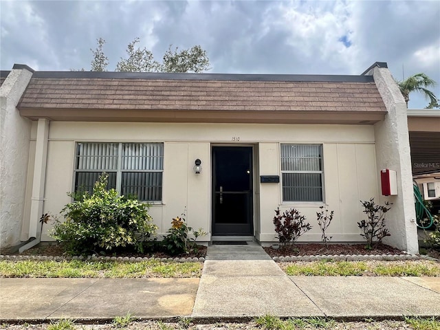 1510 Mission Hills Blvd Unit 19-F, Clearwater, FL 33759 - doorway to property with a shingled roof and mansard roof