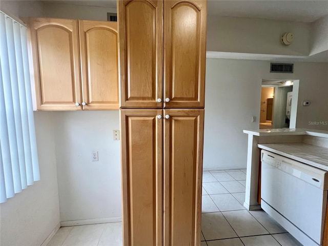 1510 Mission Hills Blvd Unit 19-F, Clearwater, FL 33759 - kitchen with white dishwasher, light tile patterned floors, light brown cabinetry, and light countertops