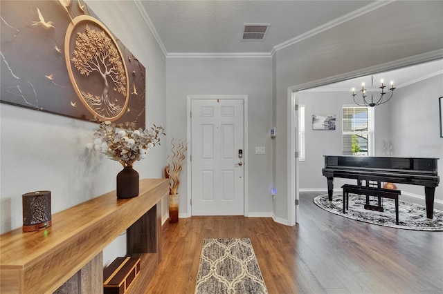 5026 Bromeliad Ave, Wimauma, FL 33598 - entrance foyer featuring wood finished floors, crown molding, a chandelier, baseboards, and a textured ceiling