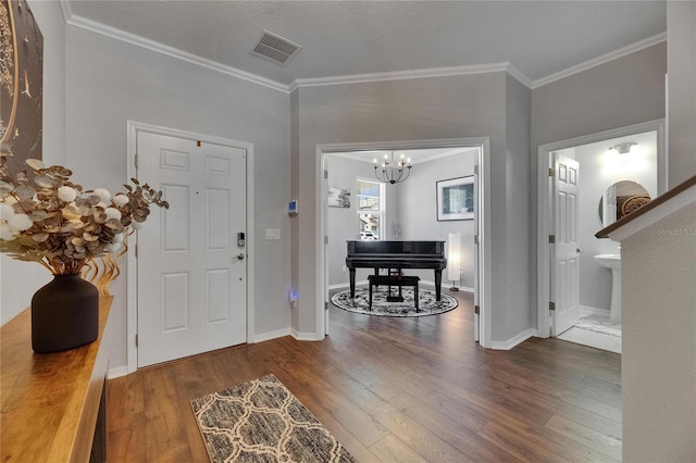 5026 Bromeliad Ave, Wimauma, FL 33598 - foyer entrance featuring wood finished floors, a chandelier, ornamental molding, and baseboards