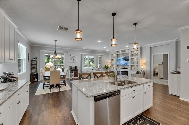 5026 Bromeliad Ave, Wimauma, FL 33598 - kitchen with stainless steel dishwasher, a sink, ornamental molding, dark wood-style floors, and open floor plan