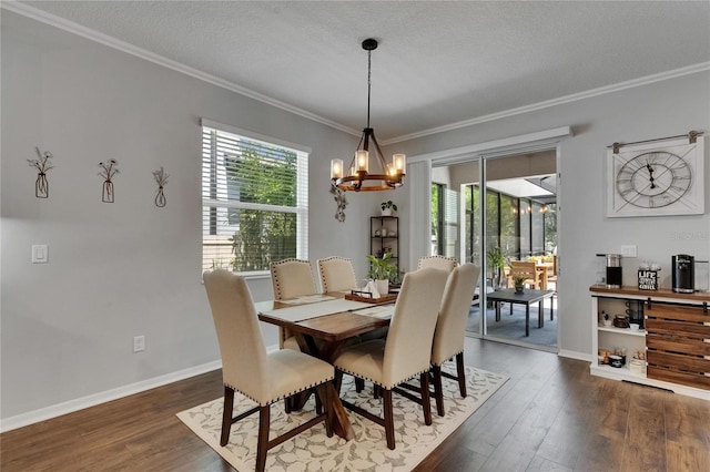 5026 Bromeliad Ave, Wimauma, FL 33598 - dining room featuring dark wood-style flooring, a chandelier, ornamental molding, baseboards, and a textured ceiling
