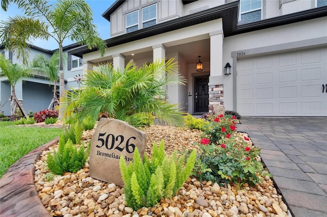 5026 Bromeliad Ave, Wimauma, FL 33598 - view of exterior entry with stucco siding and an attached garage