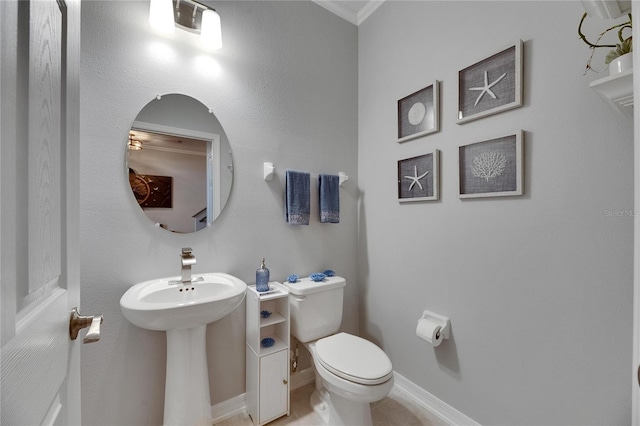 5026 Bromeliad Ave, Wimauma, FL 33598 - bathroom featuring toilet, baseboards, ornamental molding, and tile patterned floors
