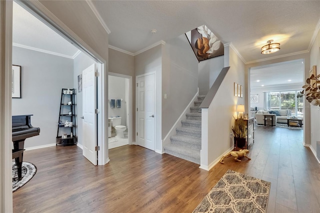 5026 Bromeliad Ave, Wimauma, FL 33598 - entryway with stairs, hardwood / wood-style floors, baseboards, and ornamental molding