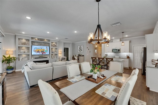 5026 Bromeliad Ave, Wimauma, FL 33598 - dining room featuring ornamental molding, a chandelier, recessed lighting, and dark wood-style flooring