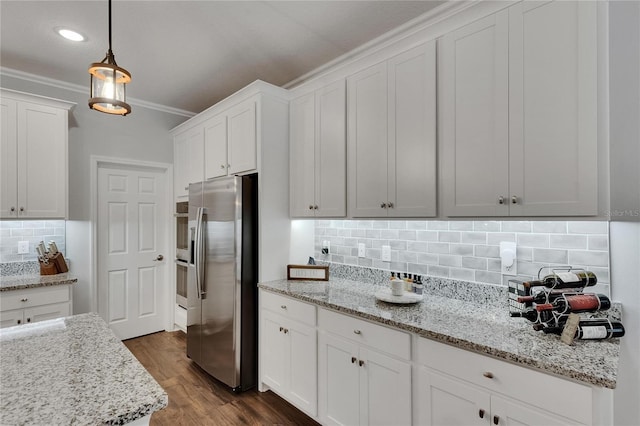 5026 Bromeliad Ave, Wimauma, FL 33598 - kitchen featuring stainless steel fridge, tasteful backsplash, white cabinets, ornamental molding, and dark wood-style floors