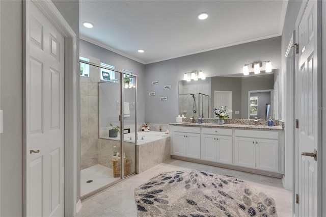 5026 Bromeliad Ave, Wimauma, FL 33598 - bathroom featuring a shower stall, a garden tub, double vanity, ornamental molding, and tile patterned flooring