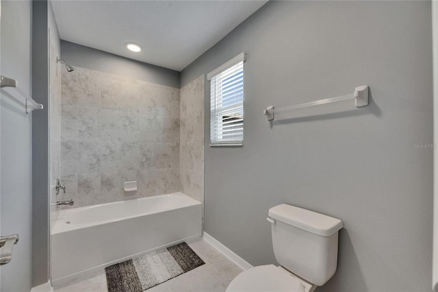 5026 Bromeliad Ave, Wimauma, FL 33598 - full bathroom featuring toilet,  shower combination, tile patterned floors, and baseboards